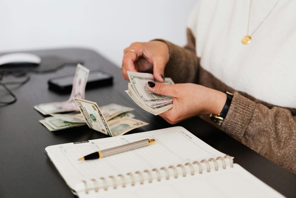 Woman with a note book counting money